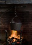 Hanging kettle over fire